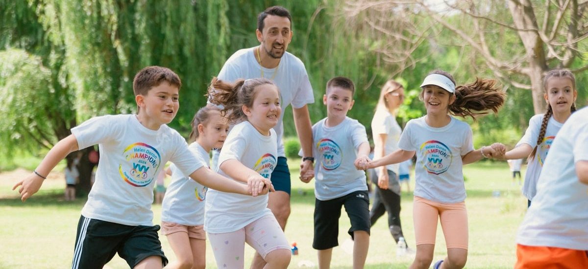 a group of young children playing a game of frisbee