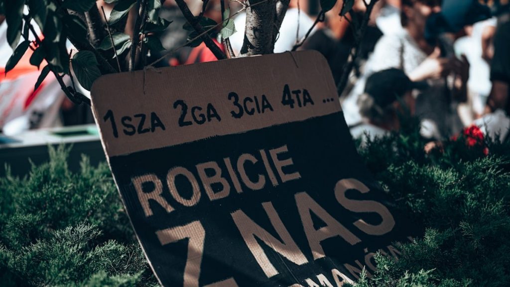 a sign in front of a crowd